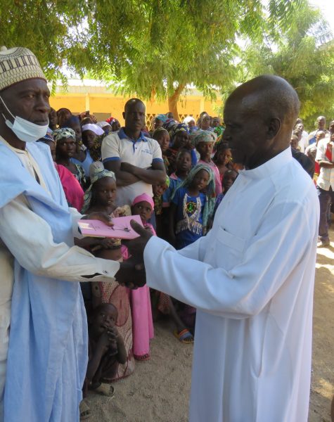 A copy of the book of Luke handed to the traditional ruler