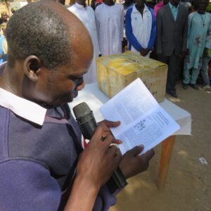 A-Mada-literacy-teacher-reading-the-health-booklet-scaled-1