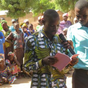 A-Mada-young-man-reading-a-portion-of-the-book-of-Luke-scaled-1